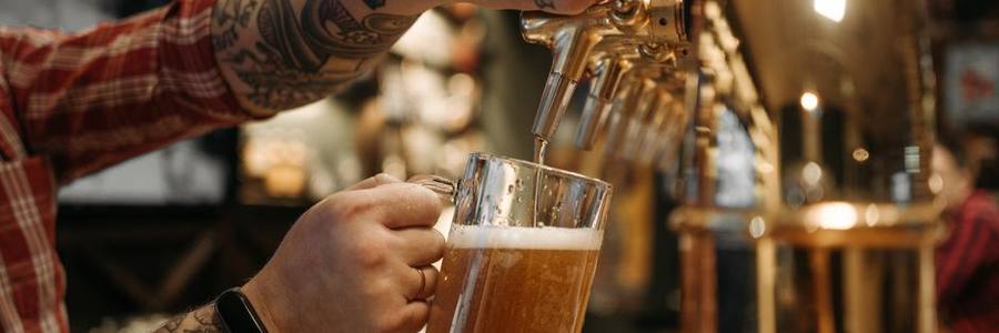 Draft beer being poured behind the bar