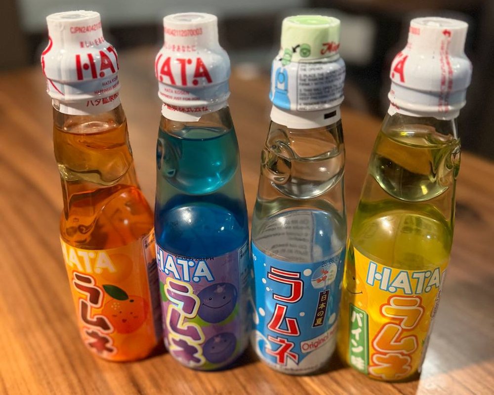 Hata Ramune bottles with their marble caps - orange, blueberry, original and pineapple