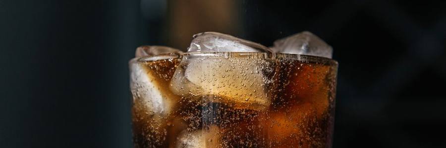 A cold fizzy drink over ice
