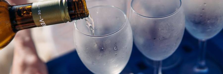 White wine poured into chilled glasses